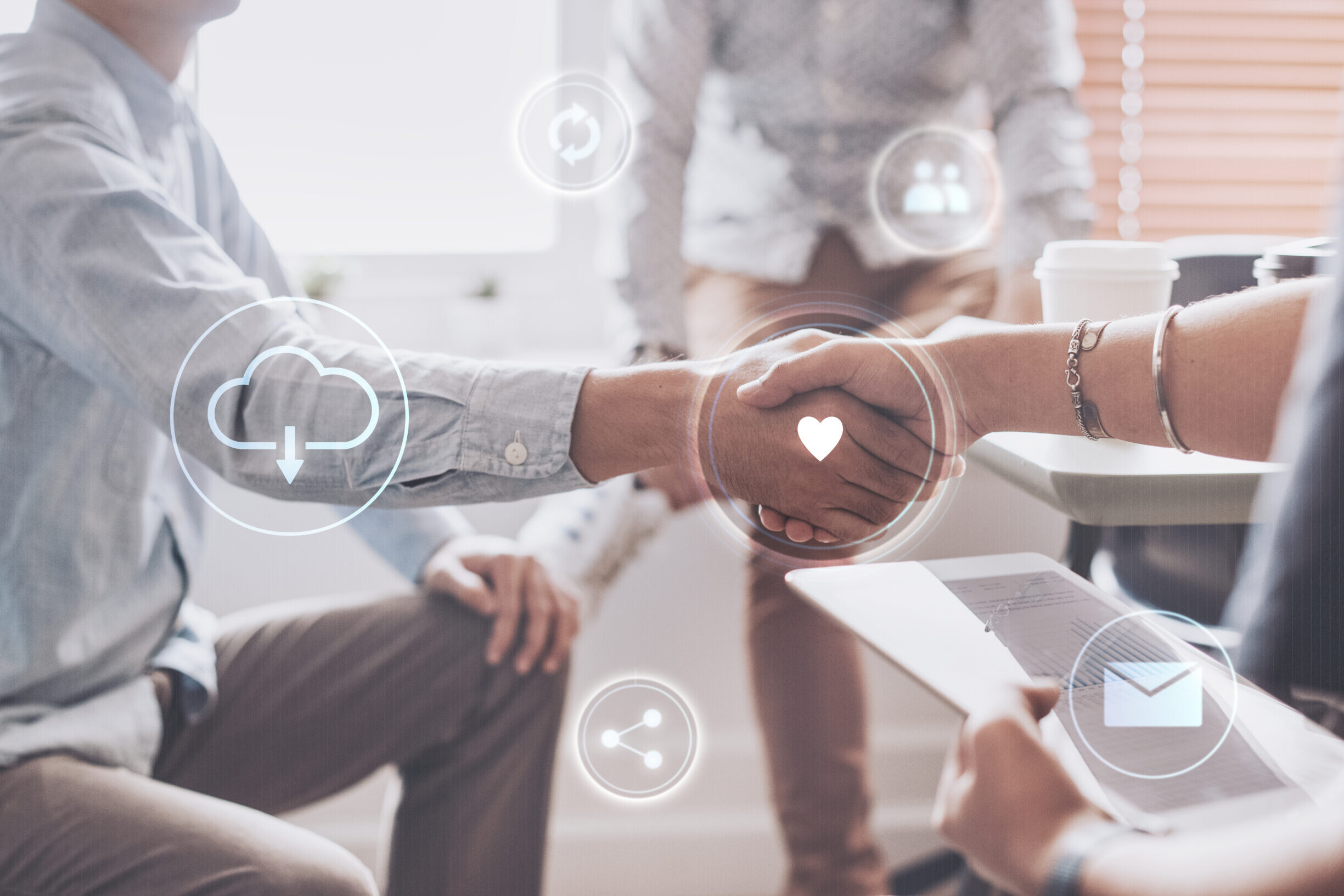 Business professionals shaking hands, symbolizing how to automate employee onboarding with digital workflows.