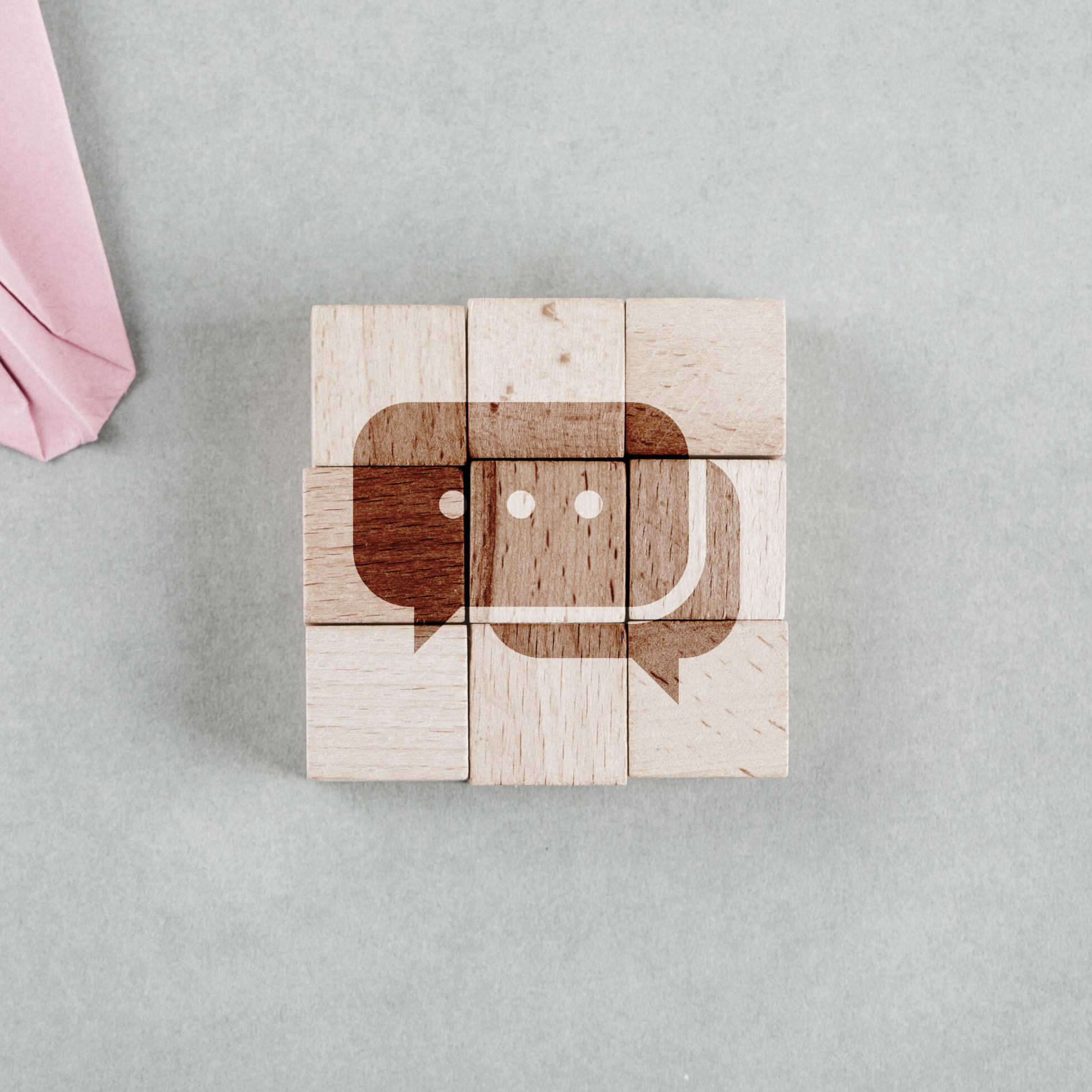 Wooden blocks forming a chat icon representing the best internal communication tools