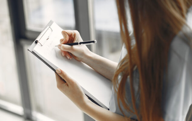 Employee onboarding checklist being filled out on a clipboard during onboarding process