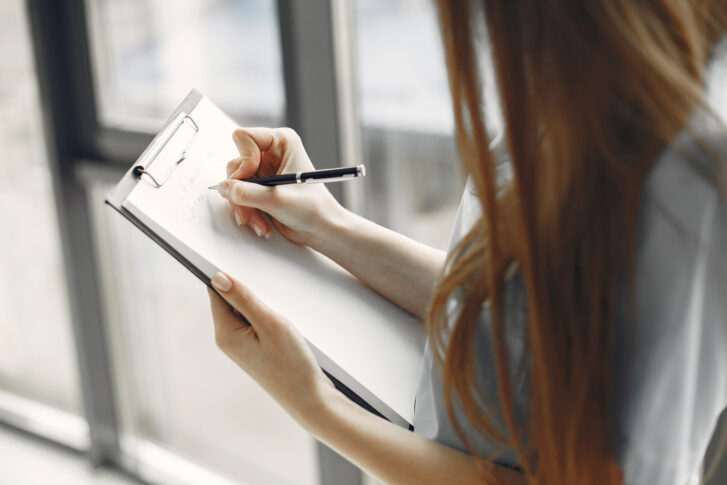 Employee onboarding checklist being filled out on a clipboard during onboarding process