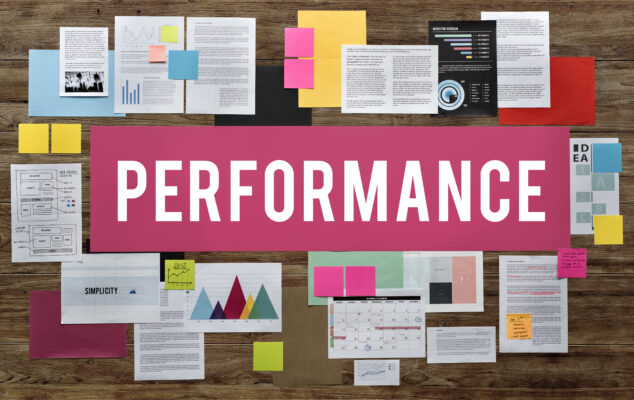 Performance improvement plan template with business documents, charts, and notes arranged on a workspace